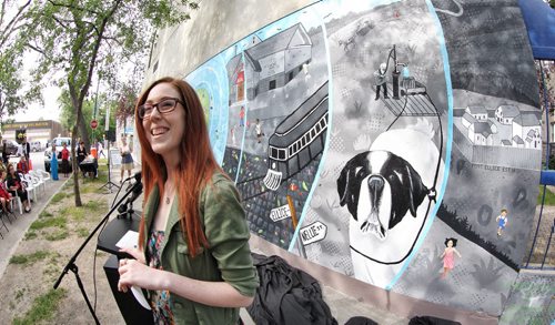 Artist Sara Wilde is all smiles after the unveiling of the mural she created along with about 200 local youth. The mural can be seen at the NW corner of Langside Street and Ellice Avenue.  140814 August 14, 2014 Mike Deal / Winnipeg Free Press