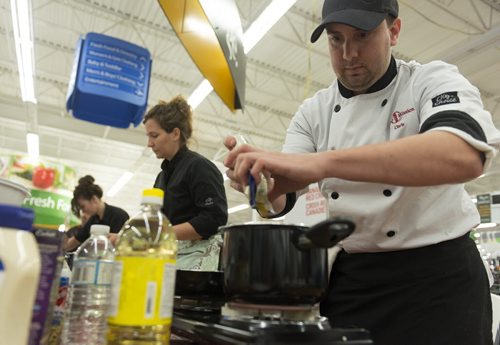 Chef and food services manager at Siloam Mission Chris Buffington participates in a cooking competition held by Walmart and Canadian Red Cross on Thursday along with chefs Heather Porteous and Korene McCaig. Sarah Taylor / Winnipeg Free Press August 14, 2014