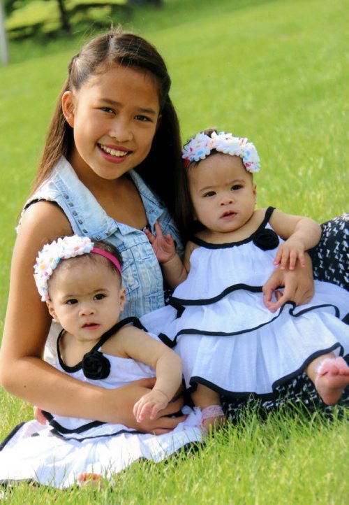 Zachi Espayos holds her sister Zayne and Zoey. Zachi is set to donate bone marrow to her twin sisters who suffer from a rare blood disorder.  (Charles Tweed/Brandon Sun)