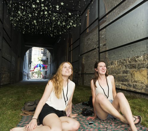 Ashley James and Emily Bews participated in Creative Place Making Challenge through Urban Idea on Friday to create stars in an alley on Arthur Street. Sarah Taylor / Winnipeg Free Press August 15, 2014