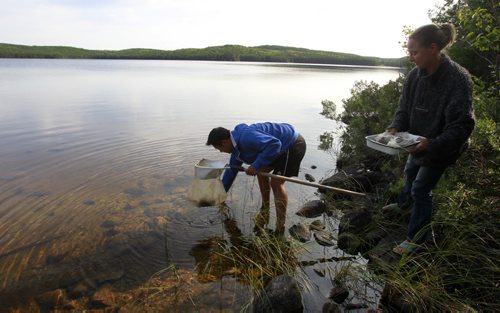 Wison Ho, grade 12 student from St. John's-Ravenscourt School goes out to retrieve his invertebrates traps in Lake #240 with assistance from Pauline Gerrard, with International Institute of Sustainable Development (IISD) . Wilson  is part of a school pilot project in the  Experimental Lakes Area (ELA) located past Kenora in Northwestern Ontario. Nick Martin story Wayne Glowacki/Winnipeg Free Press August 14 2014