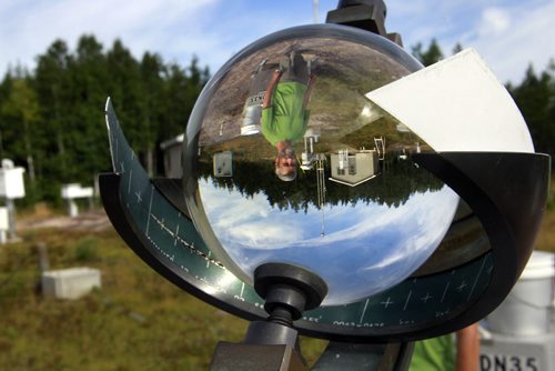 Near the Field Station, Dean McLeod is reflected in the glass sphere of a Campbell-Stokes Sunshine Recorder ( it records hours of bright sunshine by burning a trace on a card), one of the many instruments  at the Experimental Lakes Area Meteorological and Atmospheric Chemistry Monitoring Site established in 1969.  Experimental Lakes Area (ELA) are  located past Kenora in Northwestern Ontario. Nick Martin story Wayne Glowacki/Winnipeg Free Press August 14 2014