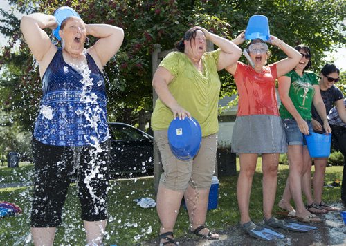 Wendy Molnar, Angela Hallam and Natalie Shaw participate in the ice bucket challenge in support of ALS on Friday at the ALS House. Molnar's mother passed away from ALS in 1997. Sarah Taylor / Winnipeg Free Press August 15, 2014