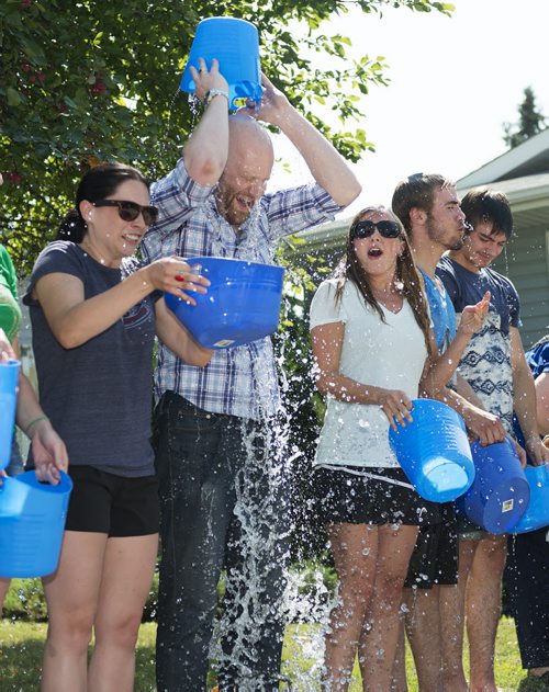 Graham Todd with Reliable Mobility Healthcare Products  dumps a buck of ice on themselves in support of ALS on Friday at the ALS House. Sarah Taylor / Winnipeg Free Press August 15, 2014