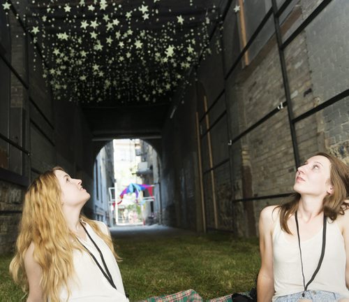 Ashley James and Emily Bews participated in Creative Place Making Challenge through Urban Idea on Friday to create stars in an alley on Arthur Street. Sarah Taylor / Winnipeg Free Press August 15, 2014