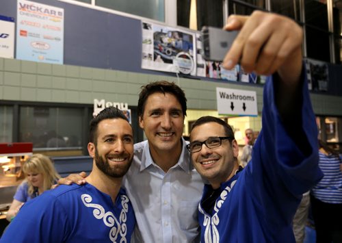 Liberal Party of Canada, Justin Trudeau, middle, poses for a selfie with Leandro Zylberman and Alex Serebnitski, dancers from the Sarah Sommer Chai Folk Ensemble, at the Israeli Folklorama Pavillion, Friday, August 15, 2014. (TREVOR HAGAN/WINNIPEG FREE PRESS)