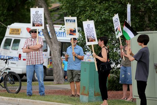 A small silent vigil held outside the Israeli Folklorama Pavillion, in support of peace and justice, Friday, August 15, 2014. (TREVOR HAGAN/WINNIPEG FREE PRESS)