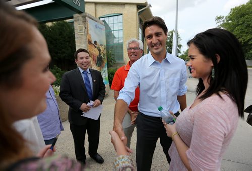 Liberal Party of Canada, Justin Trudeau, flanked by Winnipeg South Centre candidate, Jim Carr and his daughter Rebecca Carr meeting with people at the Israeli Folklorama Pavillion, Friday, August 15, 2014. (TREVOR HAGAN/WINNIPEG FREE PRESS)