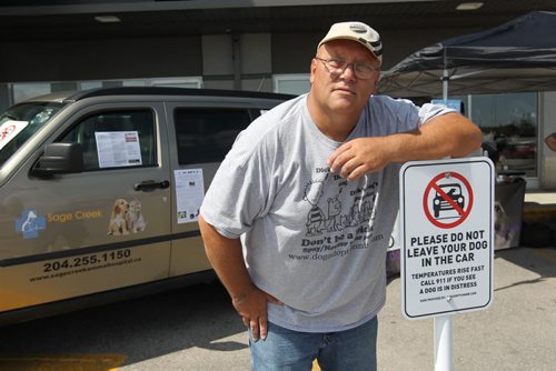 DEMONSTRATION OF DOG IN HOT CAR - Barry Piasta with Dog Adoption Manitoba stands next to new signs made to bring awareness to dog owners the danger in leaving their dogs in vehicles in warm weather at Pet Valu on Reenders Saturday.  Organizers with Save A Dog Network, Dog Adoption MB and Pet Valu hosted a Hot Car Awareness Daygiving demonstrations of how hot a car gets even with the windows open.    Aug 13, 2014 Ruth Bonneville / Winnipeg Free Press