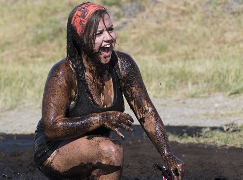 Lisa McDonald finishes the Mud Run at Springhill Winter Sports Park and Oasis Resort on Saturday in mud mayhem. Sarah Taylor / Winnipeg Free Press August 16, 2014