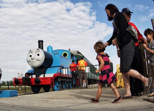 Kids get in line to have their photo taken with Thomas the Tank Engine after he pulled into The Prairie Dog Central Railway Sunday morning.  140817 August 17, 2014 Mike Deal / Winnipeg Free Press