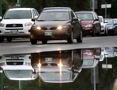 Traffic reflects on Enfield Crescent Monday morning after over night showers. Weather story Wayne Glowacki/Winnipeg Free Press August 18 2014
