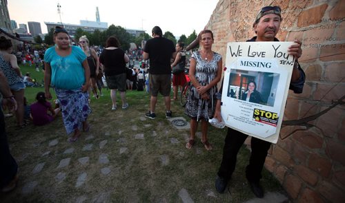 Wilfred Catcheway stands at the Forks Tuesday with a placcard describing his missing daughter Jennifer. Over a thousand people gathered to honor Tina, Faron Hall (whose body was also recovered from the river SUnday) and all missing and murdered indeginous women. August 19, 2014 - (Phil Hossack / Winnipeg Free Press)