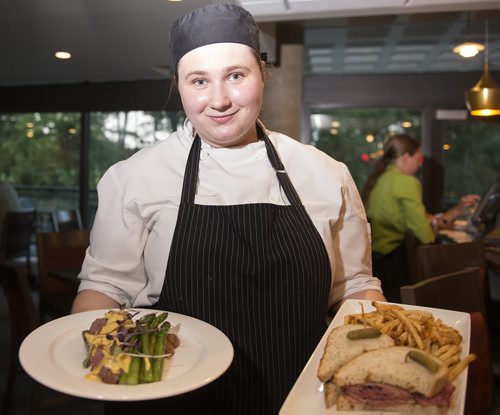 Food Evolution's sous chef Anna Damaskin with beef with lobster mushroom cream sauce with potatoes and asparagus and Mike's steamed brisket sandwich with one of five house made mustards and fries. Sarah Taylor / Winnipeg Free Press August 19, 2014