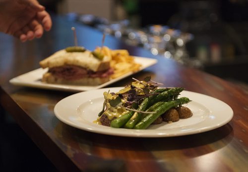 Beef with lobster mushroom cream sauce with potatoes and asparagus Mike's steamed brisket sandwich with one of five house made mustards and fries at Food Evolution. Sarah Taylor / Winnipeg Free Press August 19, 2014