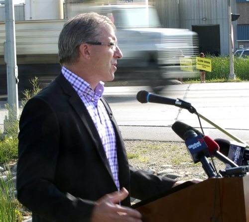Mayoral candidate Gord Steeves makes an announcement on Kenaston Blvd. Wednesday morning  with the theme photo radar must focus on safety and fairness.  A few members of WiseUpWinnipeg were also in attendance some holding signs to alert motorists to slow down photo enforcement ahead.  Bart Kives story.  Wayne Glowacki/Winnipeg Free Press August 20 2014