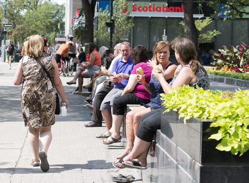 People enjoy their lunch break sitting along Broadway Avenue on Wednesday afternoon. Sarah Taylor / Winnipeg Free Press August 20, 2014