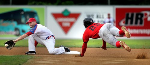 New Jersey Jackal outfielder Felix Sanchez leaps for the bag as Winnipeg Goldeye Tyler Khun reaches for the catch. Sanchez was safe on the play at second. Wednesday night at Shaw Park.  August 20, 2014 - (Phil Hossack / Winnipeg Free Press)