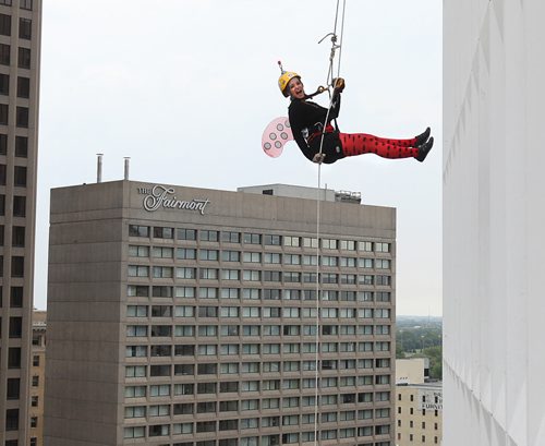 Jenna Newman bounces away from the RBC building as she rappels down 200 feet during the annual Easter Seals Drop Zone event.  Money raised in the the fundraising event  goes to Manitoban's living with disabilities.   Standup photo Aug 21, 2014 Ruth Bonneville / Winnipeg Free Press