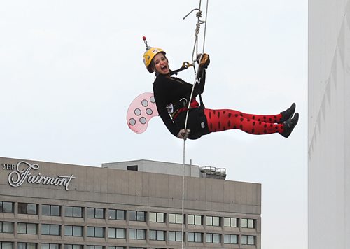 Jenna Newman bounces away from the RBC building as she rappels down 200 feet during the annual Easter Seals Drop Zone event.  Money raised in the the fundraising event  goes to Manitoban's living with disabilities.   Standup photo Aug 21, 2014 Ruth Bonneville / Winnipeg Free Press