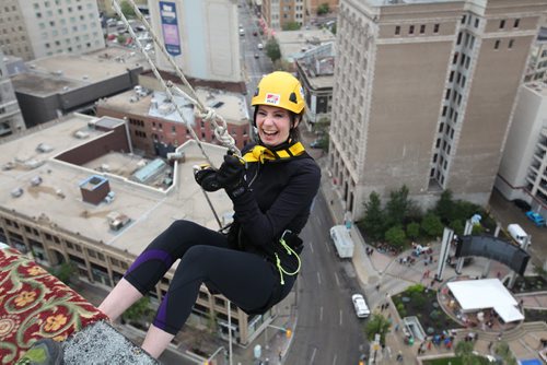 Megan Hemenway is all smiles as she steps off the ledge of the  RBC building just before she rappels down 200 feet during the annual Easter Seals Drop Zone event.  Money raised in the the fundraising event  goes to Manitoban's living with disabilities.   Standup photo Aug 21, 2014 Ruth Bonneville / Winnipeg Free Press