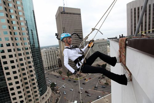 Maybelle Pacak conscientiously makes her way down the RBC building, rappelling 200 feet to the base during the annual Easter Seals Drop Zone event.  Money raised in the the fundraising event  goes to Manitoban's living with disabilities.   Standup photo  Aug 21, 2014 Ruth Bonneville / Winnipeg Free Press