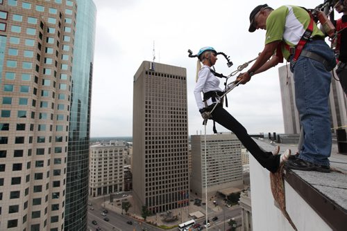 Maybelle Pacak conscientiously makes her way down the RBC building, rappelling 200 feet to the base during the annual Easter Seals Drop Zone event.  Money raised in the the fundraising event  goes to Manitoban's living with disabilities.   Standup photo  Aug 21, 2014 Ruth Bonneville / Winnipeg Free Press