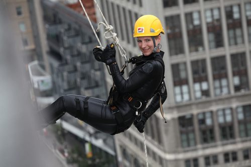 One of the participants in the Easter Seals Drop Zone is all smiles as she rappels down the  RBC building Thursday.  Money raised in the the fundraising event  goes to Manitoban's living with disabilities.   Standup photo Aug 21, 2014 Ruth Bonneville / Winnipeg Free Press