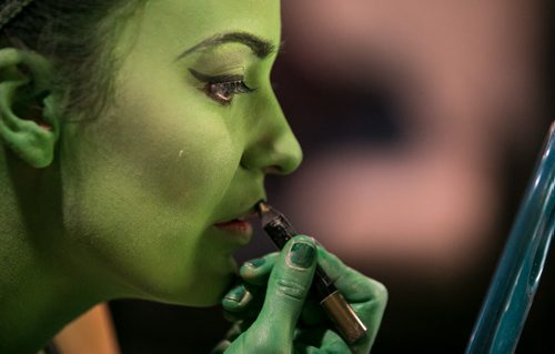 Alyssa Fox has her green makeup applied for the part of Elphaba in the musical Wicked. The makeup process that turns Fox into the Wicked Witch of the West takes about 30 minutes. Makeup artist Joyce McGilberry uses a green water-based pancake makeup, and finishes with powder, so the green won't transfer to clothes or other performers. Wicked is playing at the Centennial Concert Hall Aug 20-30 140821 - Thursday, August 21, 2014 - (Melissa Tait / Winnipeg Free Press)