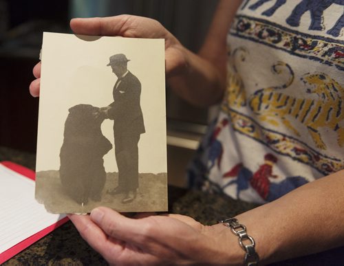 Brenda Maycher holds the photo she recently found of her grandfather Harry Colebourn and the inspiration for Winnie the Pooh and what she believes was their farewell. Colebourn bought the bear cub on his way to the First World War and eventually donated him to the London Zoo. Sarah Taylor / Winnipeg Free Press August 21, 2014