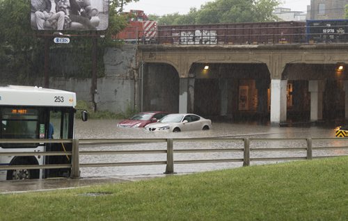 The overpass at Higgins Avenue and Main Street floods on Thursday afternoon after heavy rain. Sarah Taylor / Winnipeg Free Press August 21, 2014