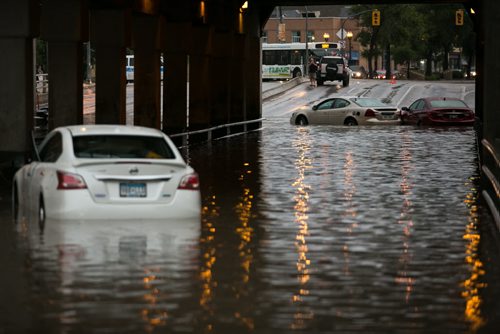 Abandoned cars at the flooded underpass at Higgins and Main Street around 8pm Thursday night.   140821 - Thursday, August 21, 2014 - (Melissa Tait / Winnipeg Free Press)