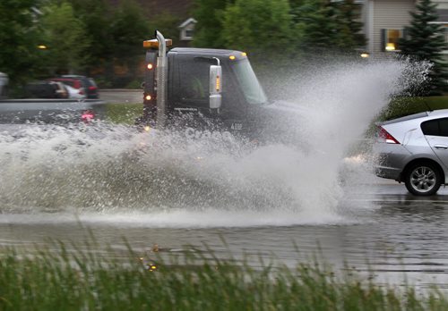 A truck hits a large puddle on Waverley St. near Wilkes Ave. Friday morning after the heavy  rainfall over night. Wayne Glowacki/Winnipeg Free Press August 22 2014