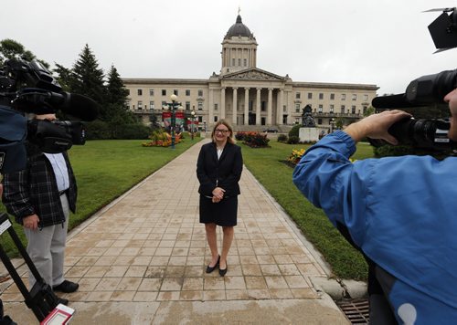Local - Paula Havixbeck  chose to use the backdrop of the Manitoba Legislature to  comment on the negative down grade of Manitoba's credit rating , she would also  put a hiring freeze at the city if elected  . Aug 22 2014 / KEN GIGLIOTTI / WINNIPEG FREE PRESS