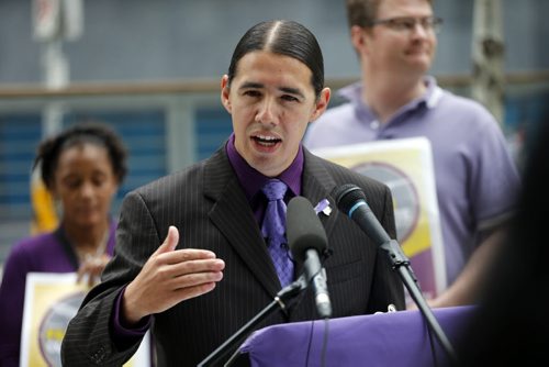 Robert-Falcon Ouellette  , mayoral candidate  was out side of the new ly constructed Police HQ's , talks about the cost over run and RCMP investigation .  Aug 22 2014 / KEN GIGLIOTTI / WINNIPEG FREE PRESS