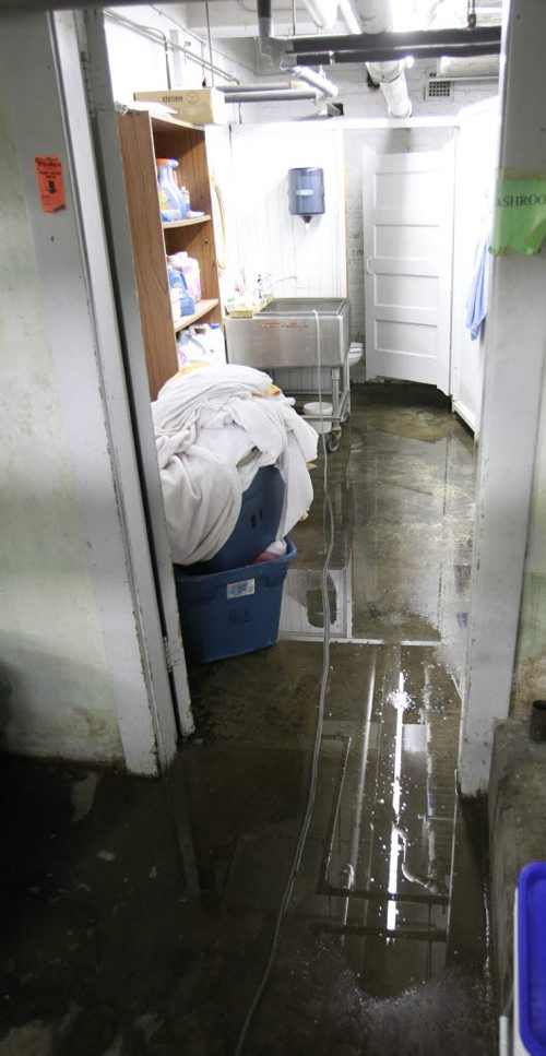 Water on the floor in the washroom in the basement of the Siloam Mission Friday after water from the overnight rain storm. Adam Wazny story Wayne Glowacki/Winnipeg Free Press August 22 2014