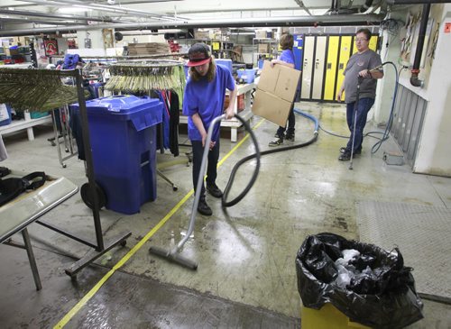 Cleaners wash and disinfect the floor of the Siloam Mission Friday after water from the overnight rain storm got into the basement. Adam Wazny story Wayne Glowacki/Winnipeg Free Press August 22 2014