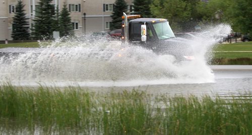 A truck hits a large puddle on Waverley St. near Wilkes Ave. after a heavy rain fall Thursday evening. Wayne Glowacki/Winnipeg Free Press August 22 2014