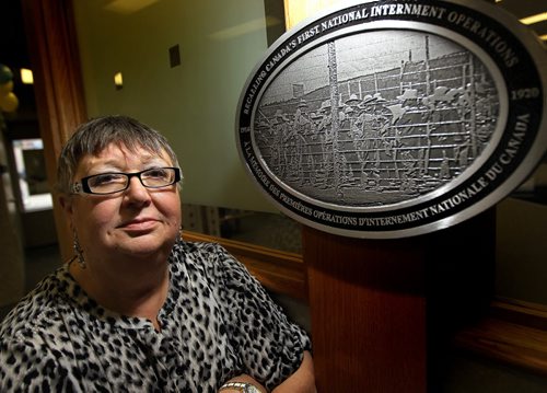 Lesia Szwaluk, exec dir of the Shevchenko Foundation poses with a plaque unveiled today. The foundation was one of 100 recipients of a plaque to mark the 100th anniversary today of the War Measures Act which interred Ukrainians and other eastern Europeans during the First World War.  See release/story. August 22, 2014 - (Phil Hossack / Winnipeg Free Press)