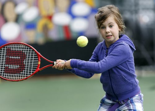 STDUP - Emma Yard age 5, takes a volley with her dad Chris Yard  in the kid zone of the Manshield Futures  tennis tournament  going on all weekend at the Winnipeg lawn Tennis Club , the  5th biggest tennis tournamnet in Canada .  Aug 22 2014 / KEN GIGLIOTTI / WINNIPEG FREE PRESS