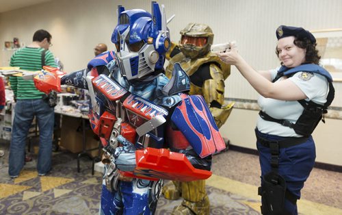 Gregory Marrast with Higher Functions Productions dresses up as Optimus Prime along with James Antoine as Griff from Halo Red vs. Blue and Sheila Breer as Jill Valentine from Resident Evil on Saturday at the Transformers Convention at the Clarion Hotel. Sarah Taylor / Winnipeg Free Press August 23, 2014