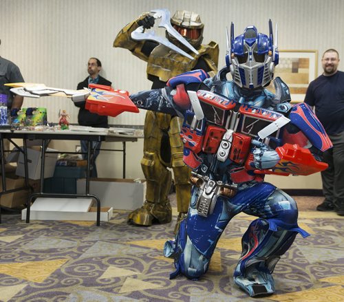 Gregory Marrast with Higher Functions Productions poses dressed up as Optimus Prime while James Antoine as Griff from Halo Red vs. Blue attacks at Saturday's Transformers Convention at the Clarion Hotel. Sarah Taylor / Winnipeg Free Press August 23, 2014