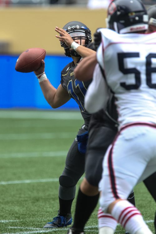 Winnipeg Rifles' QB Tyler Vieira (11) throws the ball during a game against the Calgary Colts at Investors Group Field Sunday afternoon.  140824 - Sunday, August 24, 2014 -  (MIKE DEAL / WINNIPEG FREE PRESS)