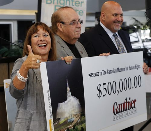 Stdup - LOCAL STDUP - Jim Gauthier  of Jim Gauthier Auto Group donates $500,000 to the Canadian Museum for Human Rights ,this is his second donation , the first was for $1,000,000. Gail Asper  received  the donation . A very happy (LtoR) Gail Asper givess a thumbs up , with Jim and son Randy Guathier  donating the the check .  Aug 25 2014 / KEN GIGLIOTTI / WINNIPEG FREE PRESS