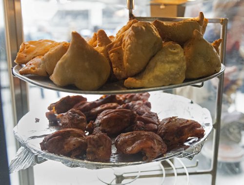 Clay Oven, samosas on top shelf, tandoori chicken on bottom tray. Sarah Taylor / Winnipeg Free Press August 22, 2014. Romona Goomansingh's story