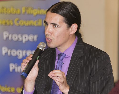 Robert-Fallon Ouellette speaks at Sisler High School Tuesday night as Manitoba Filipino Business Council confirms eight out of nine mayoral candidates. Sarah Taylor / Winnipeg Free Press August 26, 2014
