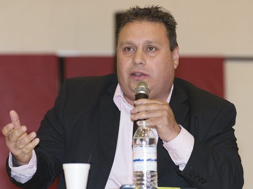 Mike Vogiatzakis speaks at Sisler High School Tuesday night as Manitoba Filipino Business Council confirms eight out of nine mayoral candidates. Sarah Taylor / Winnipeg Free Press August 26, 2014