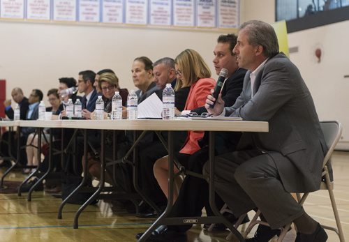 Mayoral candidates prepare speak at Sisler High School Tuesday night as Manitoba Filipino Business Council confirms eight out of nine mayoral candidates. Sarah Taylor / Winnipeg Free Press August 26, 2014