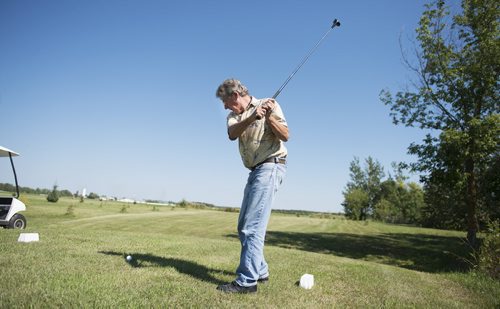 Jerry Cousins tees off on the golf course he and his wife Juanita started building in 2008 on their 65 acre property in Whitemouth. Although the two aren't avid golfers they enjoy playing on their quieter and less competitive course. Sarah Taylor / Winnipeg Free Press August 27, 2014 Bill Redekop story