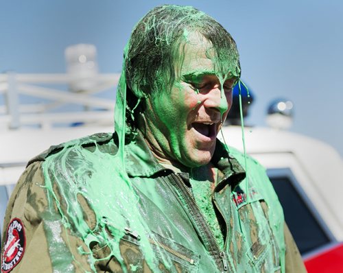 James Thevenot gets a bucket of green slime and ice dumped on him by his kids at Six Pines Haunted Attractions on Wednesday. Sarah Taylor / Winnipeg Free Press August 27, 2014